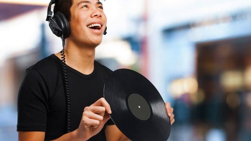 Holding a vinyl record by the edges