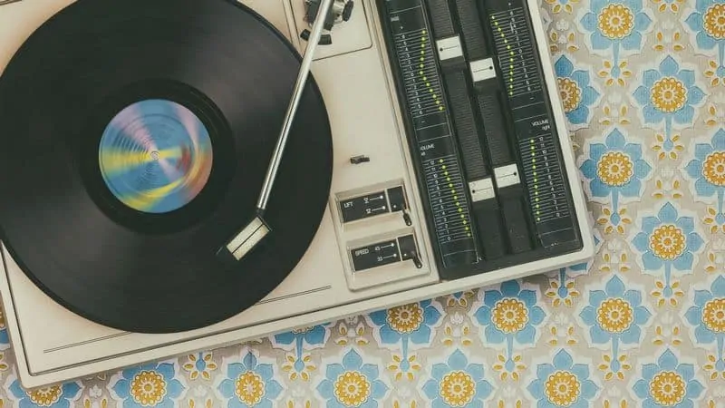 Record player on top of flower wallpaper