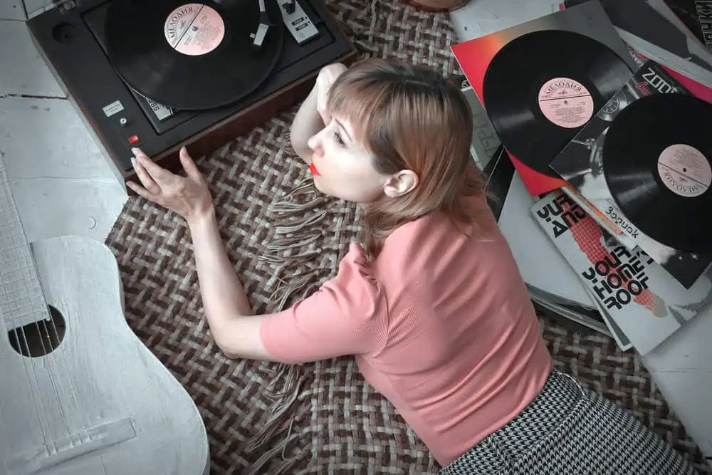 woman using safe record player